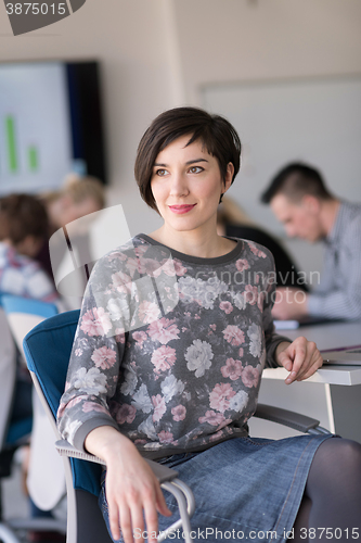 Image of portrait of young business woman at office with team on meeting 