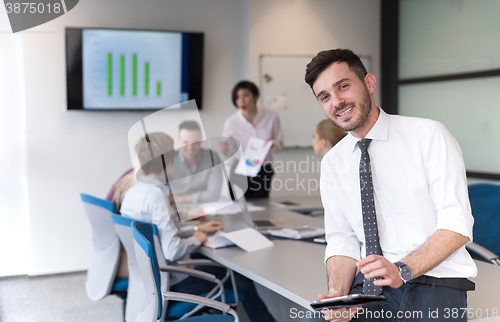 Image of young business man with tablet at office meeting room