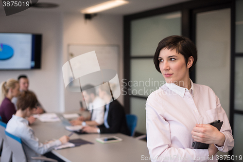 Image of hispanic businesswoman with tablet at meeting room