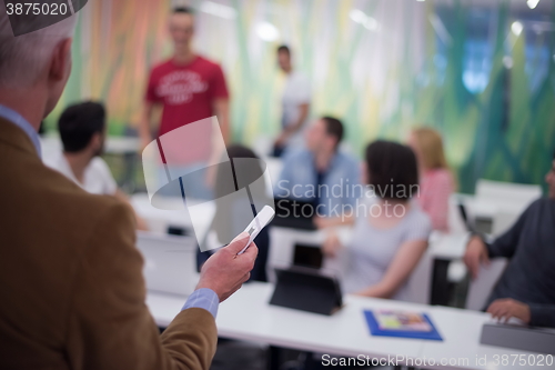 Image of teacher with a group of students in classroom