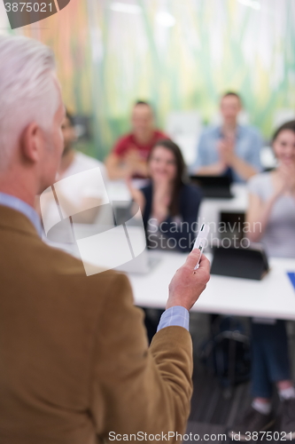 Image of teacher with a group of students in classroom