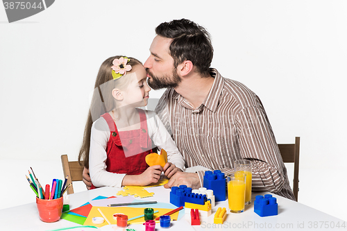 Image of Father and daughter playing educational games together 