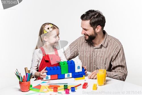 Image of Father and daughter playing educational games together 