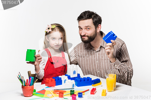 Image of Father and daughter playing educational games together 