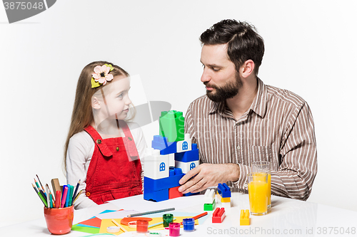 Image of Father and daughter playing educational games together 