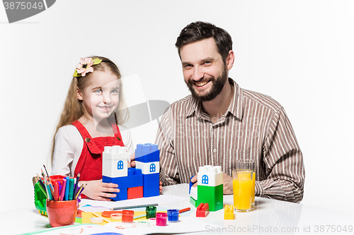 Image of Father and daughter playing educational games together 