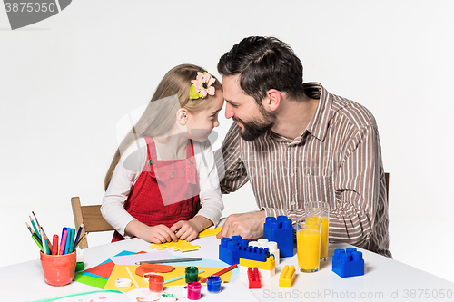 Image of Father and daughter playing educational games together 