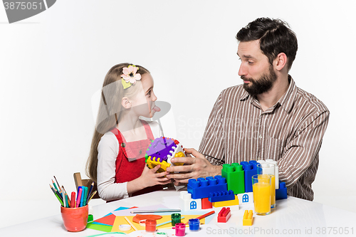 Image of Father and daughter playing educational games together 