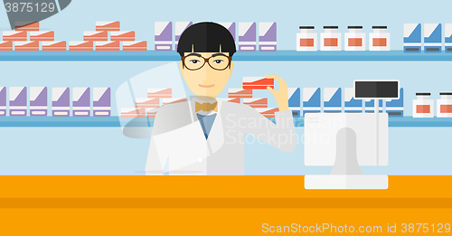 Image of Pharmacist showing some medicine.