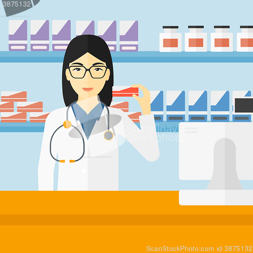 Image of Pharmacist showing some medicine.