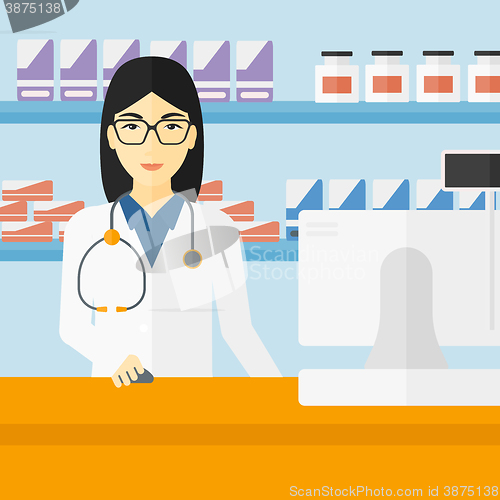 Image of Pharmacist at counter with computer monitor.