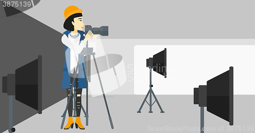 Image of Photographer working with camera on a tripod.