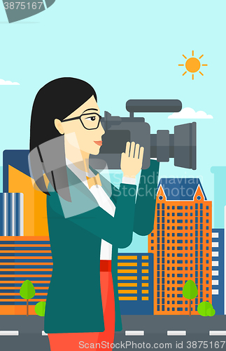 Image of Camerawoman with video camera.