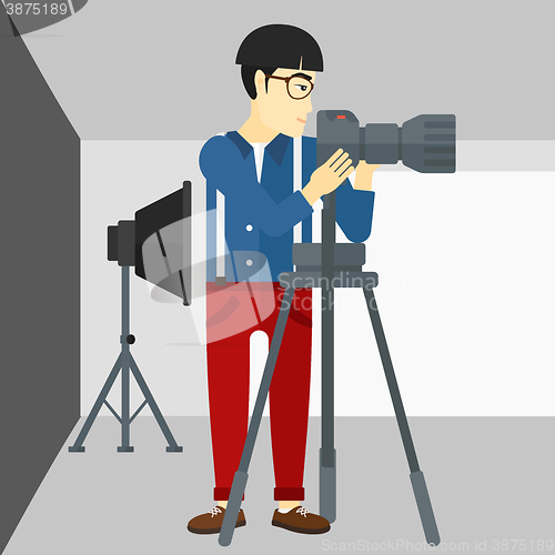 Image of Photographer working with camera on a tripod.