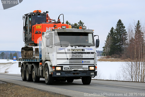 Image of Scania 143M Truck Hauls Excavator