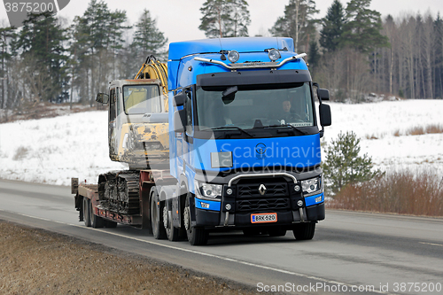 Image of Blue Renault Trucks T Hauls Construction Equipment