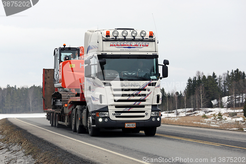 Image of White Scania Truck Hauls Hitachi Zaxis Medium Excavator 