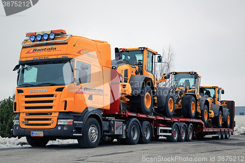 Image of Yellow Scania Hauls Long Load