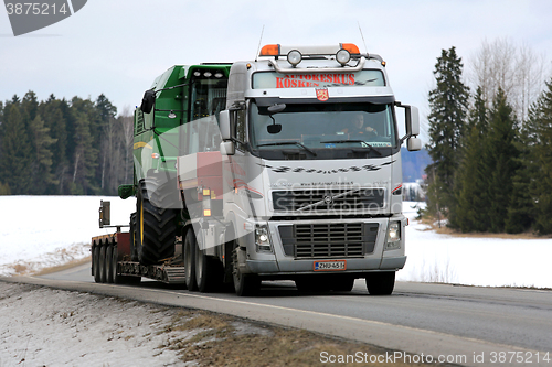 Image of Volvo FH Hauls John Deere Combine