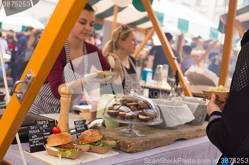 Image of Women serving hamburgers on food festival in Ljubljana, Slovenia.