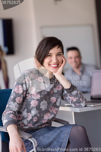 Image of portrait of young business woman at office with team on meeting 