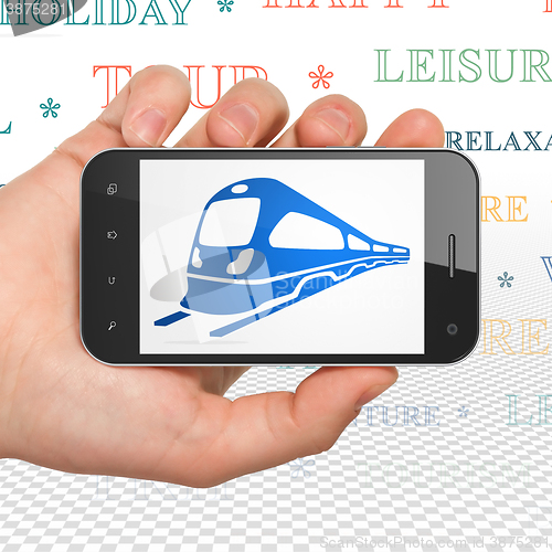 Image of Vacation concept: Hand Holding Smartphone with Train on display