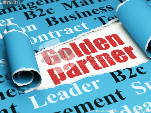 Image of Finance concept: red text Golden Partner under the piece of  torn paper