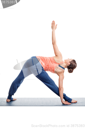 Image of Sporty woman practices Ashtanga Vinyasa yoga asana