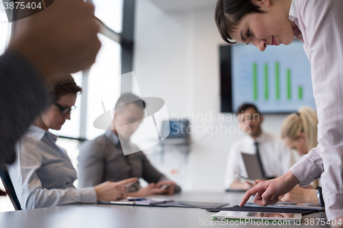 Image of young  woman using  tablet on business meeting