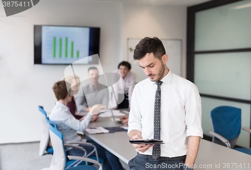 Image of young business man with tablet at office meeting room