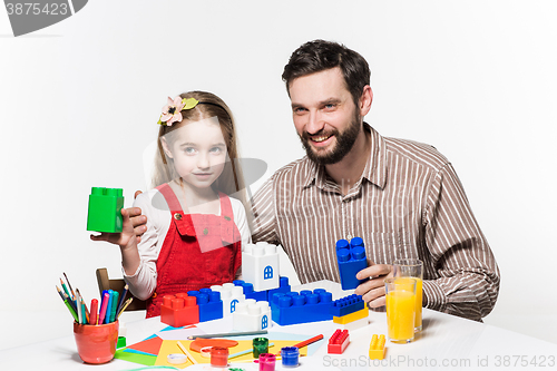 Image of Father and daughter playing educational games together 