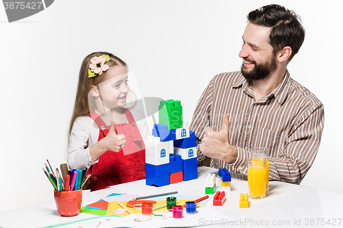 Image of Father and daughter playing educational games together 