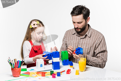 Image of Father and daughter playing educational games together 