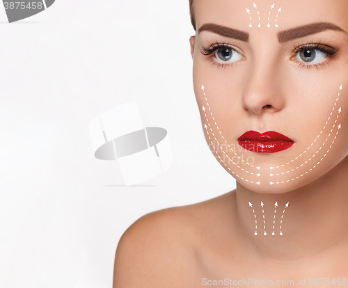 Image of The beautiful woman face  with arrows close up over white background