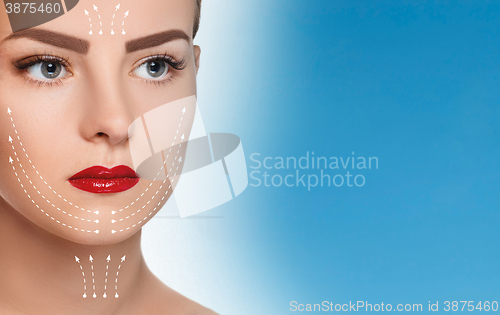 Image of The beautiful woman face  with arrows close up over blue background