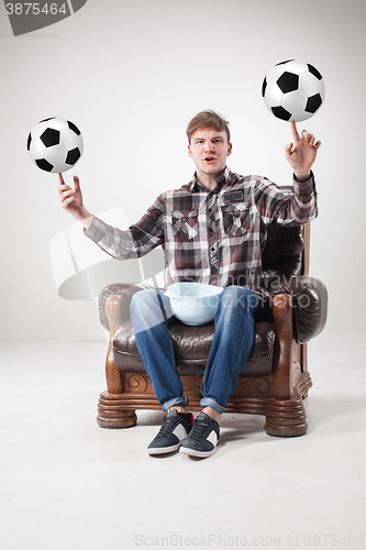Image of The portrait of fan with balls, holding dish on gray background
