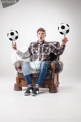 Image of The portrait of fan with balls, holding dish on gray background