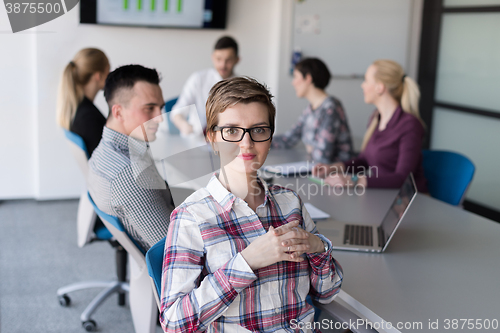 Image of portrait of young business woman at office with team on meeting 