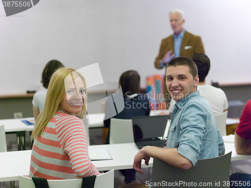 Image of teacher with a group of students in classroom