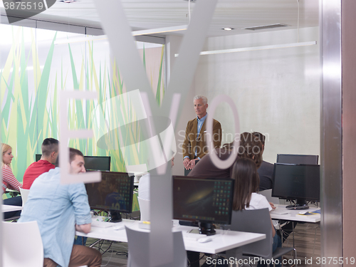 Image of senior teacher and students group in computer lab classroom