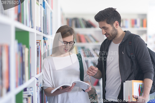 Image of students couple  in school  library