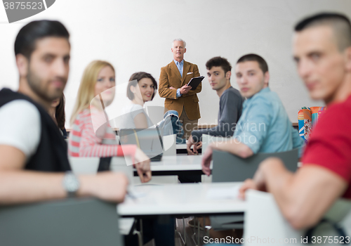 Image of teacher with a group of students in classroom