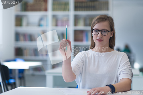 Image of female student study in school library