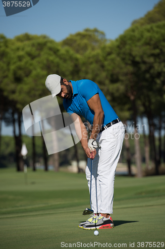 Image of golf player hitting shot at sunny day