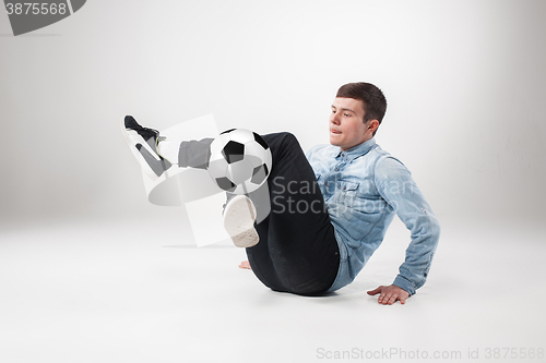 Image of The portrait of fan with ball on gray background