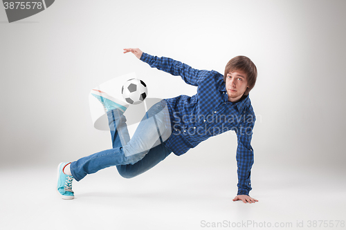 Image of The portrait of fan with ball on gray background