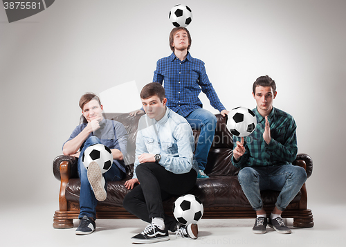 Image of The four guys with balls on gray background