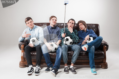 Image of The four guys with balls on gray background