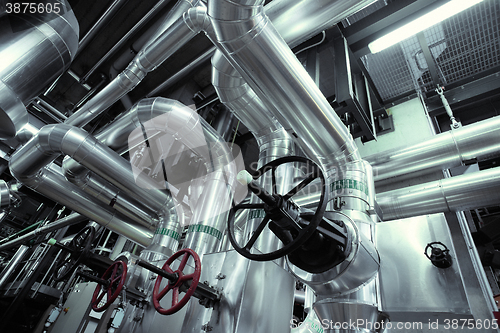 Image of Equipment, cables and piping as found inside of a modern industrial power plant