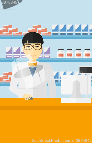 Image of Pharmacist at counter with computer monitor.